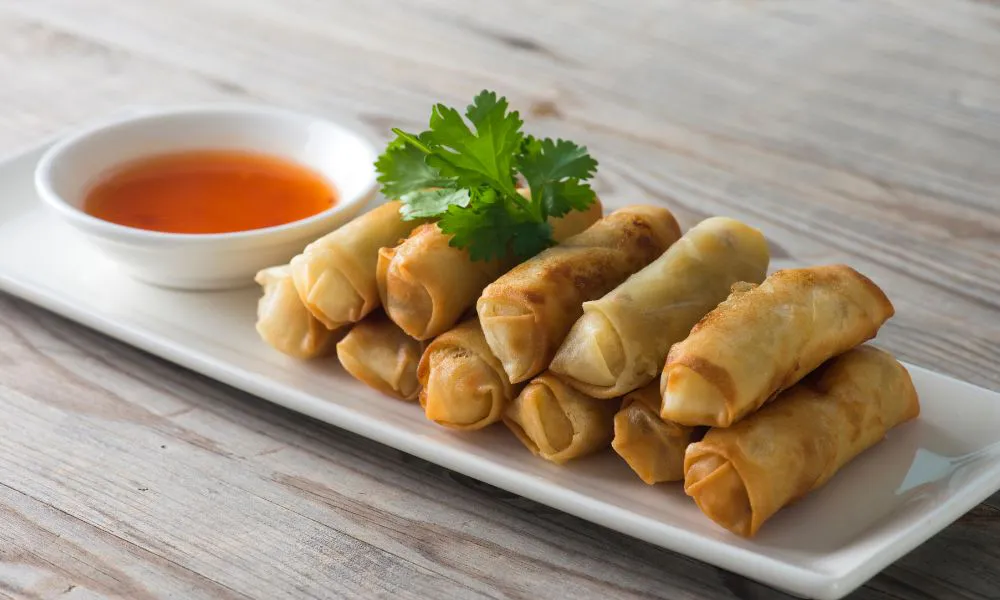 Crispy fried spring rolls with sweet chili sauce and cilantro at SANKU MAOTS'AI-LA, a Chinese Restaurant in City of Industry